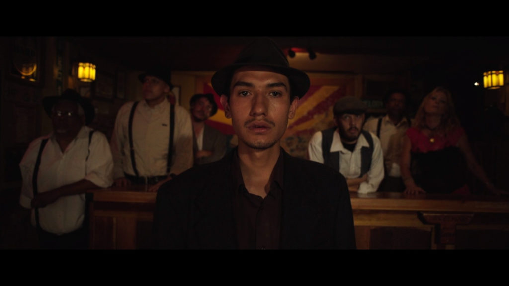 Reenactor in the film Bisbee 17, man standing in front of the Arizona flag